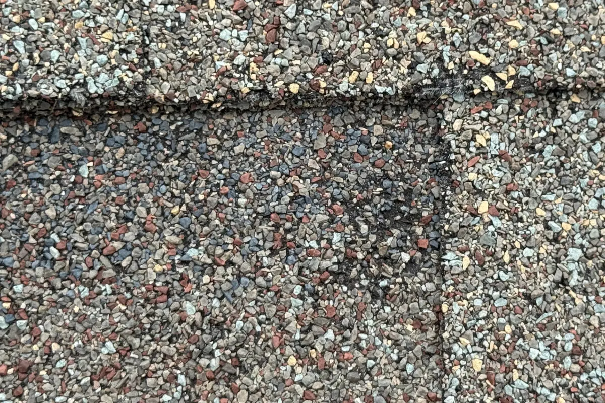 Hail damage on asphalt shingles before roof replacement in Helotes, TX