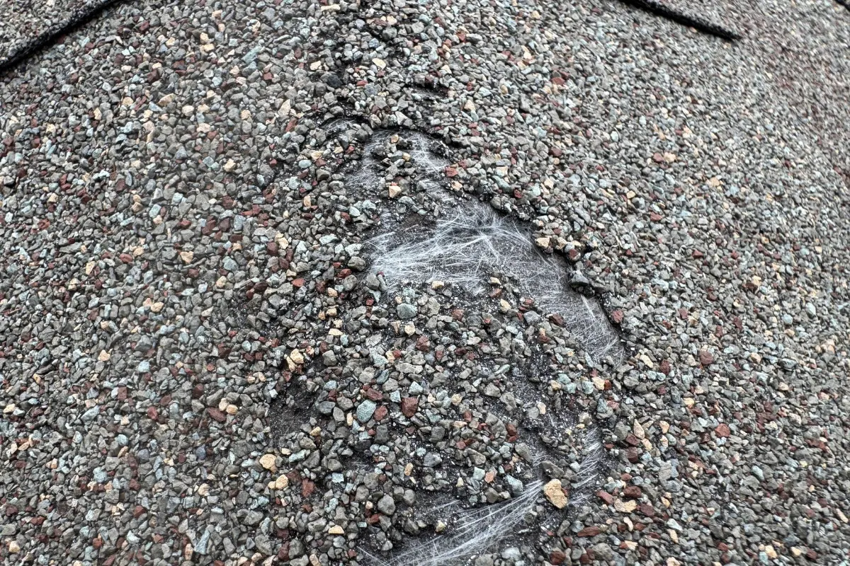 Fiberglass mat exposed due to an incorrectly installed ridge cap