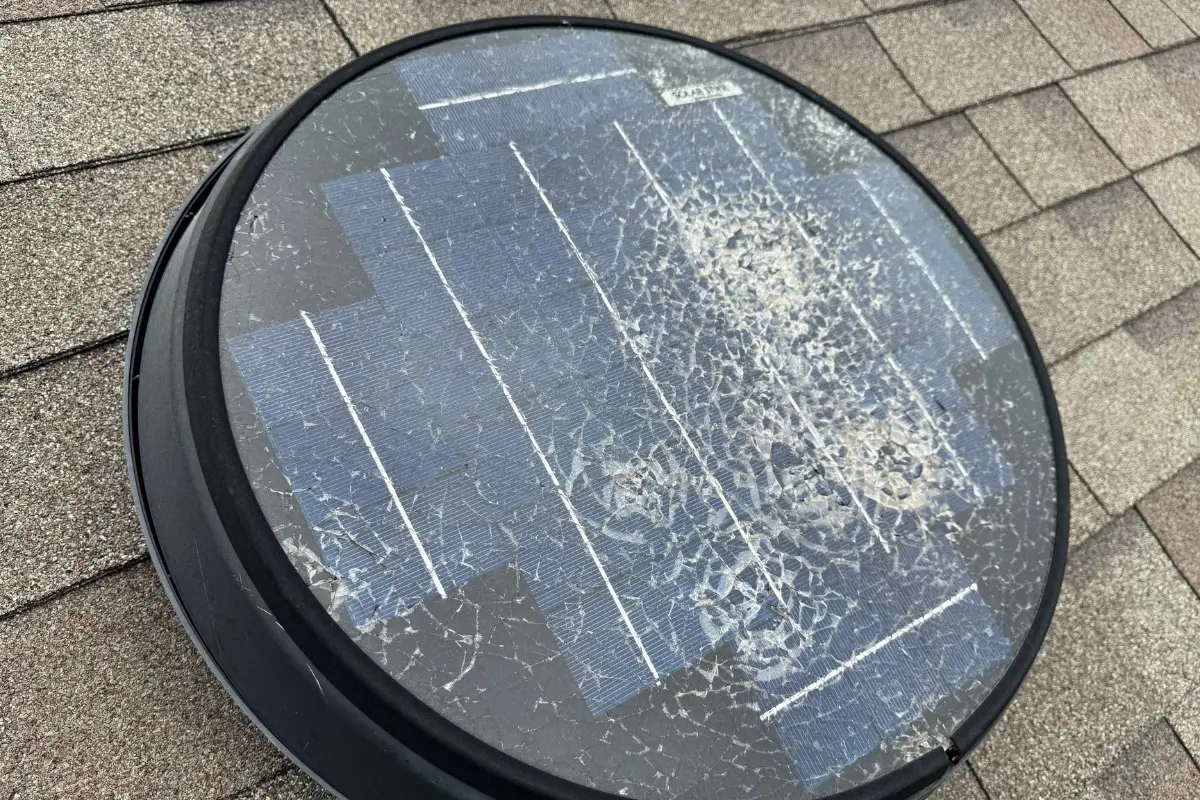 Storm-damaged solar attic fan before replacement