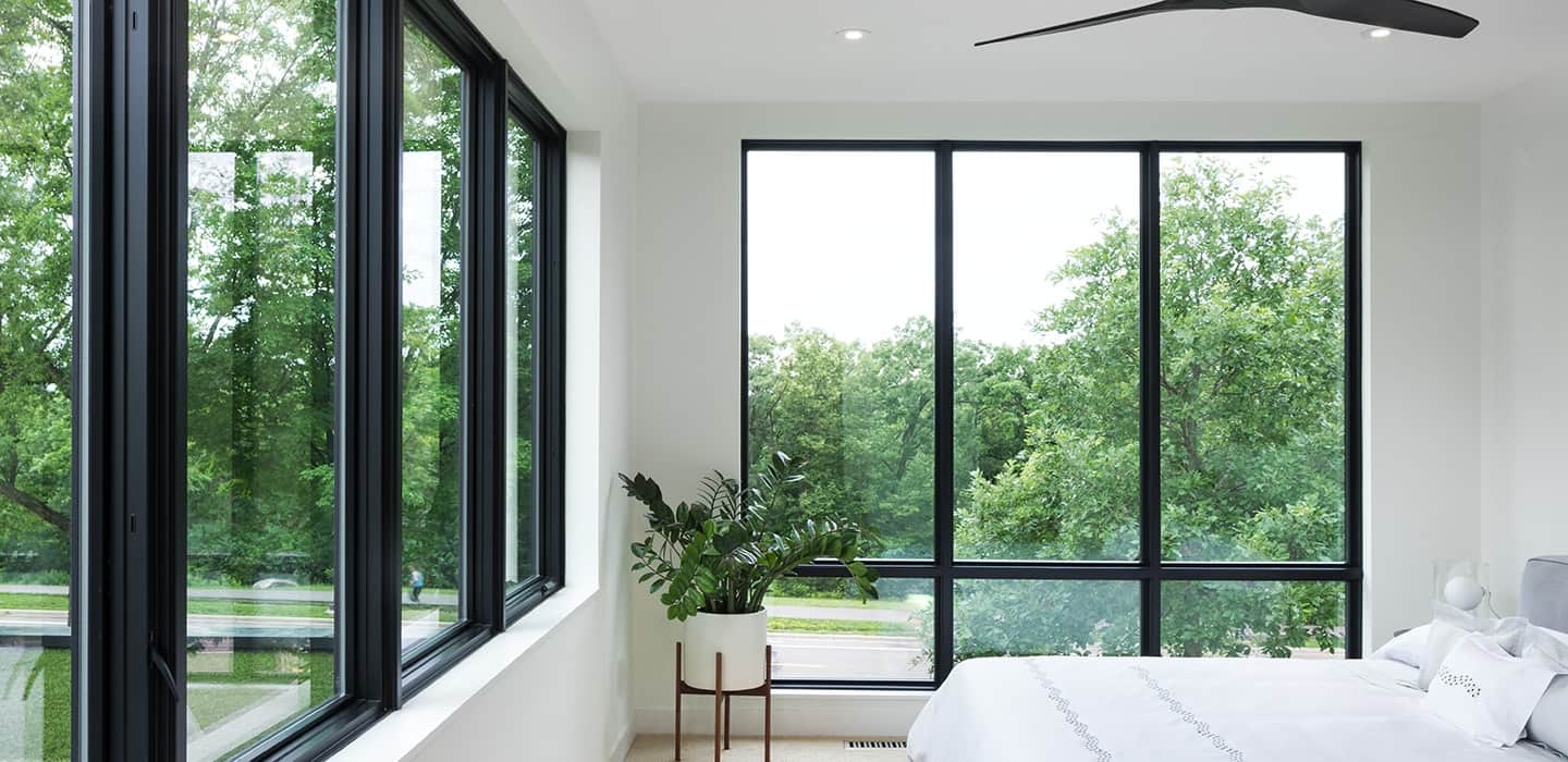 Black framed Pella windows in a typical residential bedroom