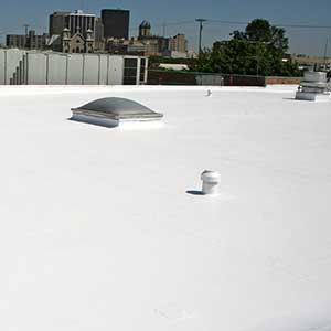 Overview of a typical white, flat commercial roof by Carlisle