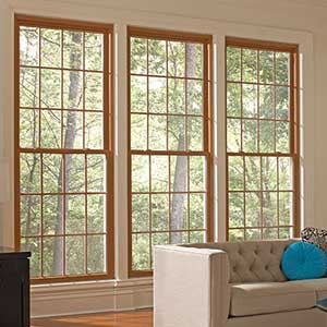 Brown framed Mezzo windows behind a sofa in a typical residential living room