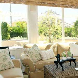 White framed NT windows behind a sofa in a typical residential living room