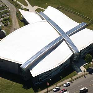 Top view of a uniquely shaped commercial building with a white, flat roof by Versico